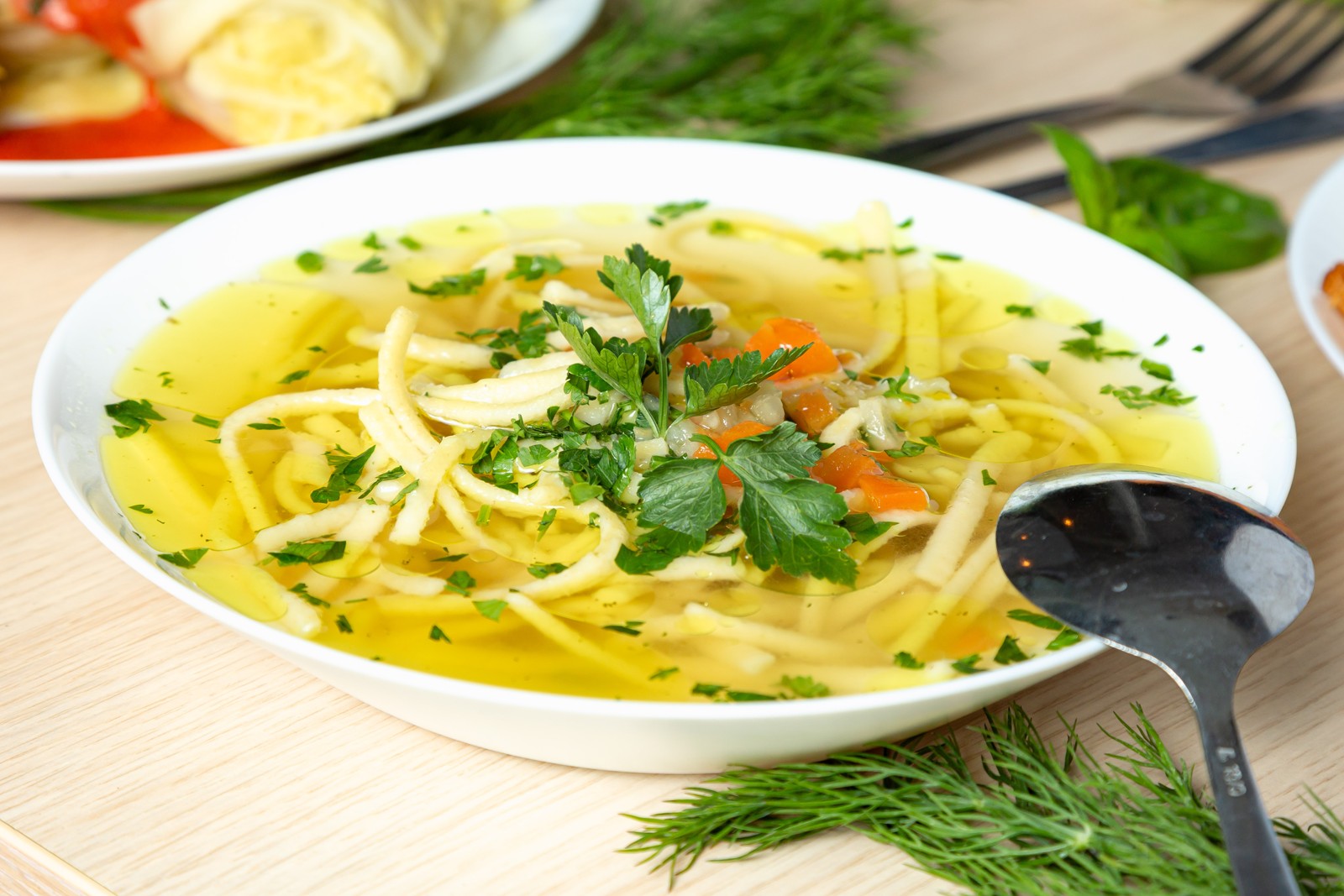 Chicken noodle soup in a white bowl