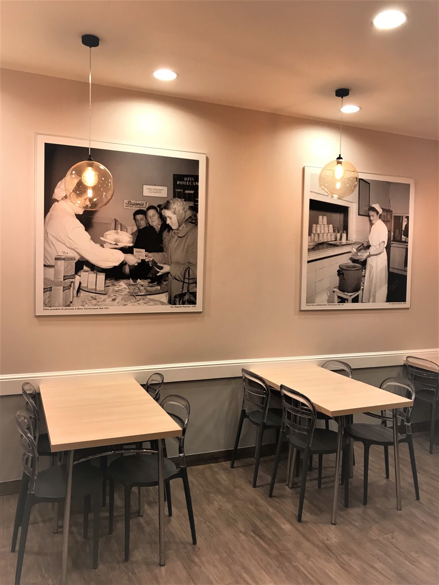 Interior of Bar Turystyczny on Szeroka — tables and historic photos on the wall